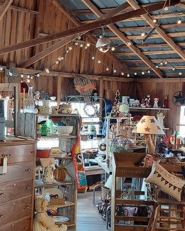 Vintage store interior with wooden shelves and various items on display.