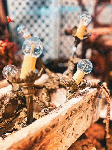 Decorative lamps with clear glass bulbs on a rustic wooden surface.