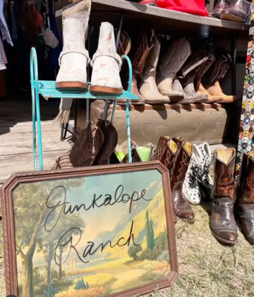 Display of boots with a 'Junkalope Ranch' sign in the foreground.