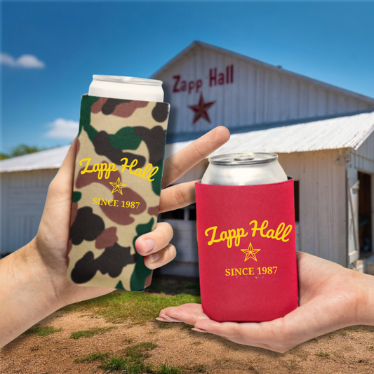 Two hands holding cans with Zapp Hall branding in front of a barn.