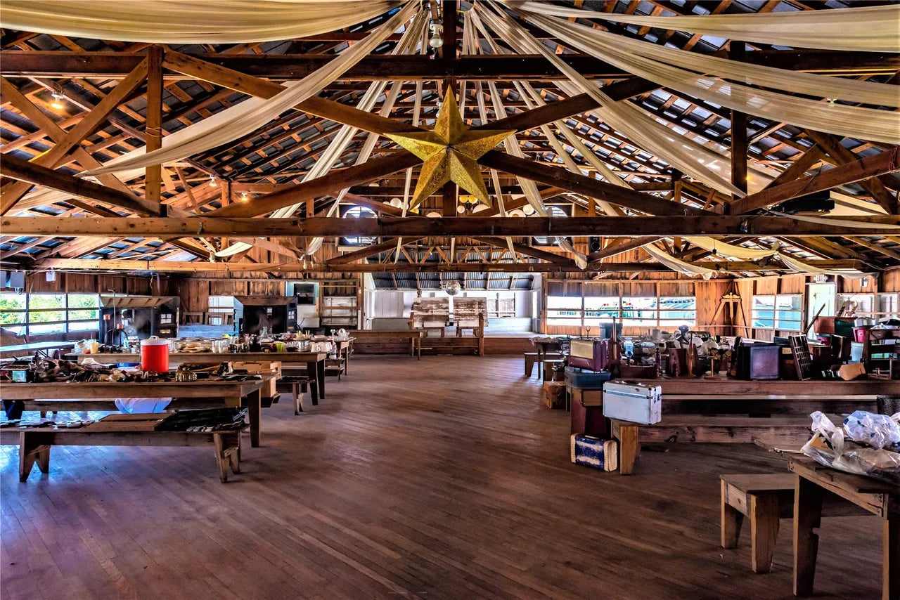 Large indoor wooden building with high ceilings and exposed beams.